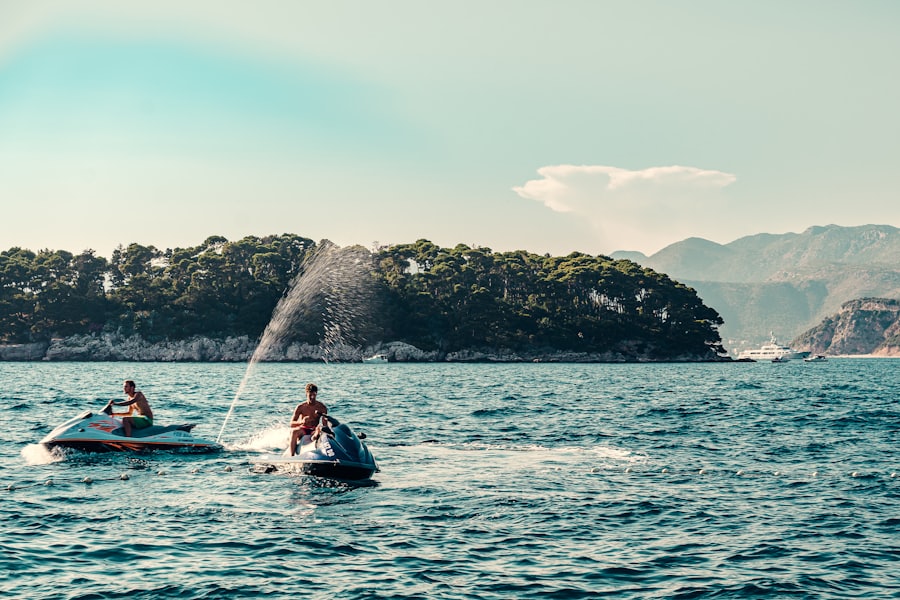 Two people riding jet skis on the water